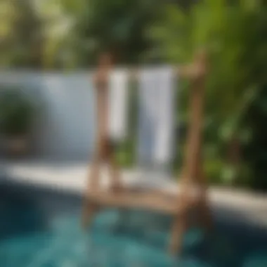 Stylish wooden towel rack by the pool with tropical plants