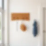 A minimalist wooden coat rack mounted on a wall in a modern entryway