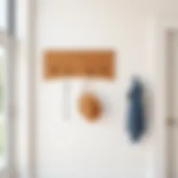A minimalist wooden coat rack mounted on a wall in a modern entryway