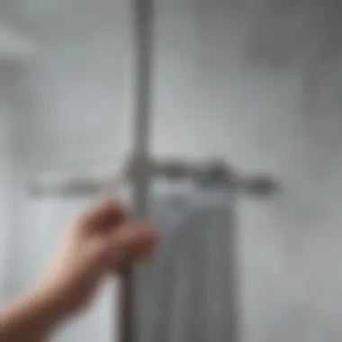 Detailed view of installation technique for tension shower rod.