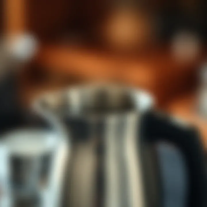 Close-up of a frothing pitcher showing the spout and handle